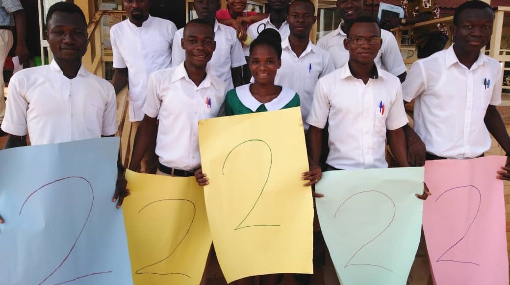 Group of 5 kids holding drawed number 2 signs -- Ghana water projects