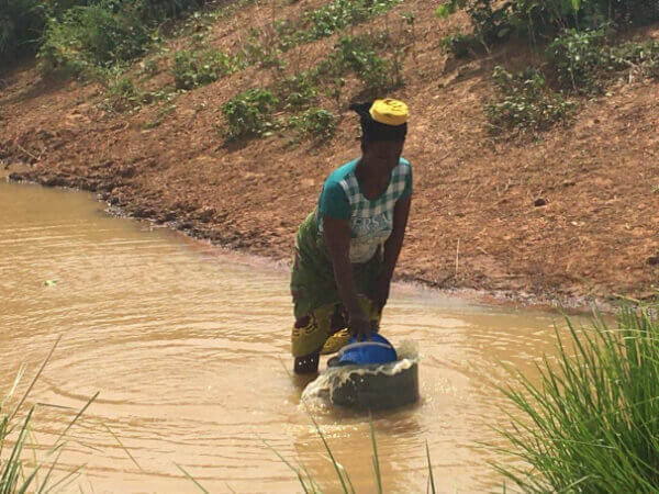 woman collecting dirty water